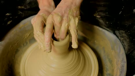 Professional-male-potter-working-in-workshop