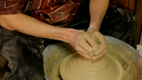 Professional-male-potter-working-in-workshop