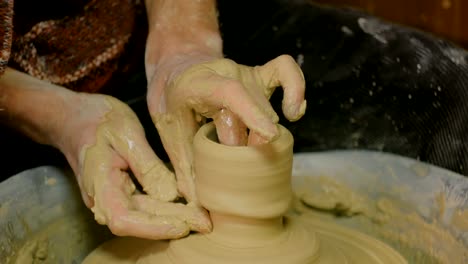 Professional-male-potter-working-in-workshop