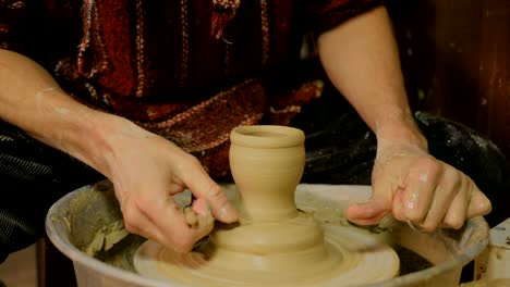 Professional-male-potter-working-in-workshop,-studio