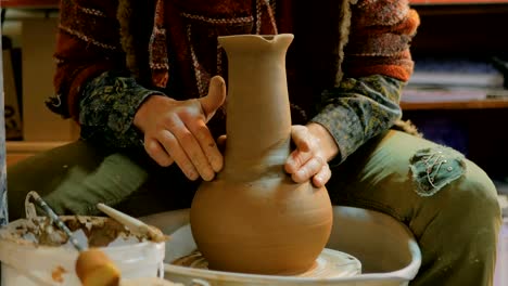 Professional-male-potter-working-in-workshop,-studio