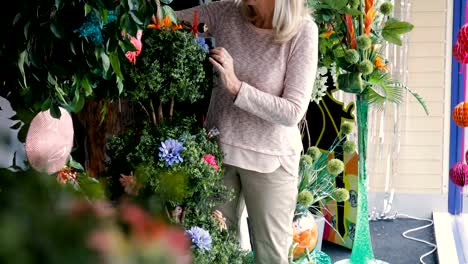 Senior-Business-Owner-Mending-her-Plants