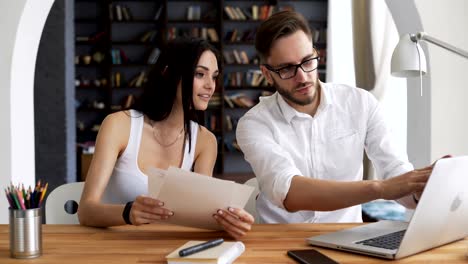 Two-start-up-partners-discuss-and-smile