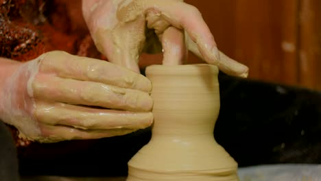 4-shots.-Professional-male-potter-making-mug-in-pottery-workshop