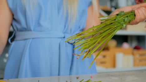 Professional-florist-cutting-flower-stems-at-studio