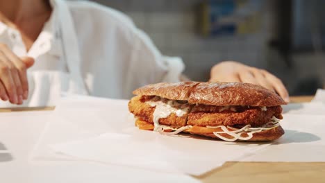 Staff-preparing-sandwiches-at-a-delicatessen,-mid-section