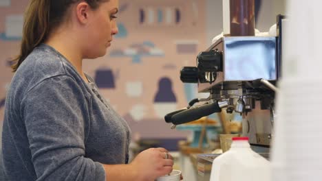 Woman-at-cookie-shop-preparing-coffee-at-an-espresso-machine