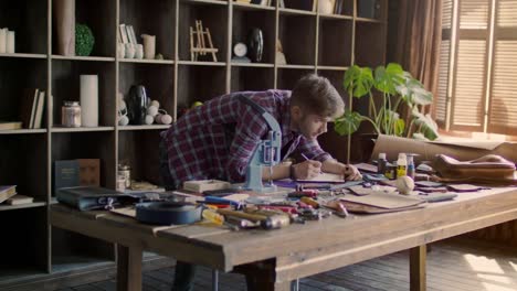 Leather-maker-working-in-home-office.-Small-business-owner-at-leather-production