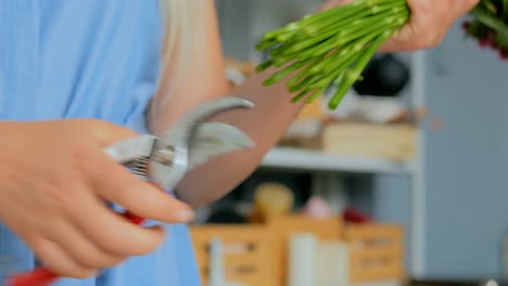 Professional-florist-cutting-flower-stems-at-studio