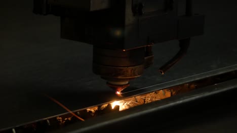 Laser-cut-machine-while-cutting-the-sheet-metal-with-sparks-and-high-precision