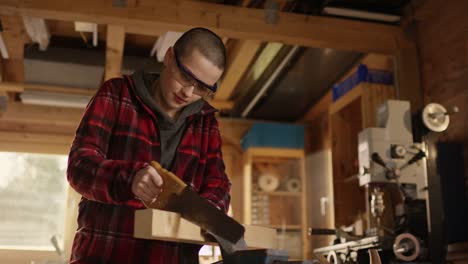 Young-woman-sawing-in-the-workshop-of-her-dad