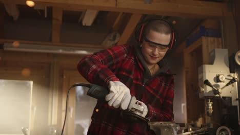 Portrait-of-powerful-Woman-with-angle-Grinder-smiling-into-camera