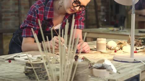 Young-Hipster-Painting-Handmade-Goods-in-her-Studio