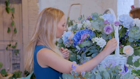 Florist-making-large-floral-basket-with-flowers-at-flower-shop