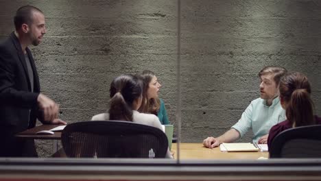 Colleagues-talking-in-a-small-business-meeting