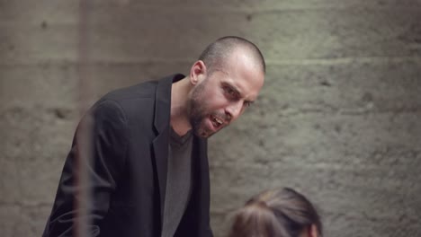 Close-up-of-an-angry-man-leading-a-small-business-meeting-and-leaving-the-room