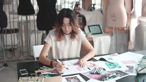 Designer-draw-sketches-in-the-Studio.-Workspace-designer.-fashion-designer-works-in-the-atelier