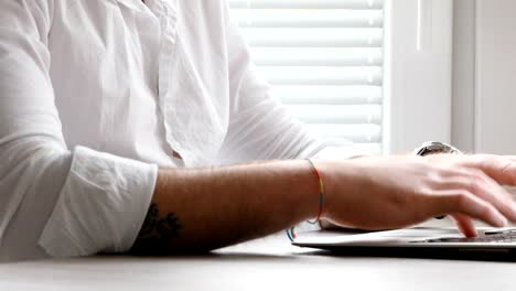 man-writing-then-smiling-to-camera---closeup