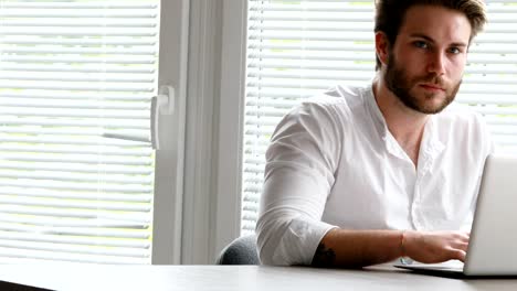 man-writing-then-smiling-to-camera