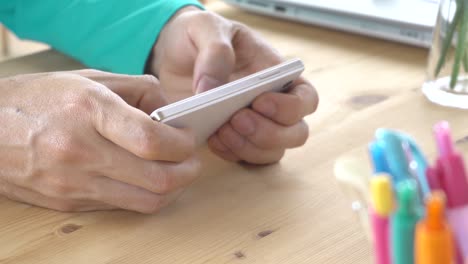 Grüne-lange-Ärmel-T-Shirt-Geschäftsmann-Chat-oder-schreiben-oder-spielen-horizontale-Smartphone-Nahaufnahme