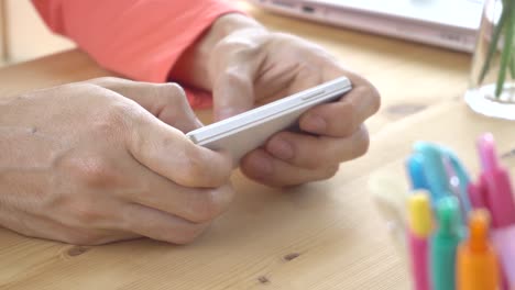 Orange-Long-Sleeve-T-Shirt-Businessman-Chat-or-Typing-or-Play-Horizontal-Smartphone-Close-Up-View