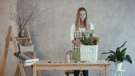 Smiling-florist-carrying-wicker-basket-with-flowers