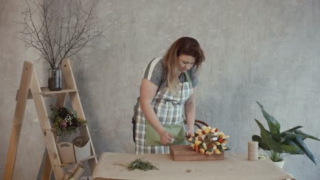 Cheerful-woman-showing-assembled-edible-bouquet