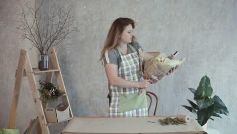 Woman-decorating-edible-arrangement-with-herbs