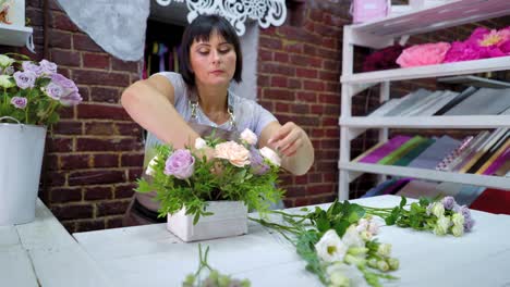 timelapse-professional-florist-arranging-flower-composition-in-wooden-box-in-floral-design-studio