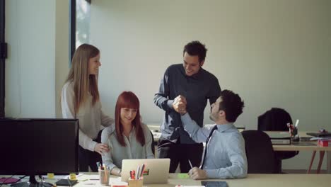 Successful-businesspeople-with-laptop-in-office