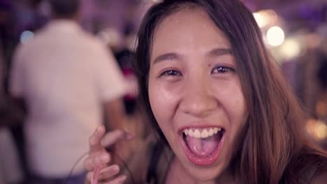 Backpacker-Asian-women-blogger-traveling-drinking-alcohol-or-beer-and-dancing-with-friends-and-using-smartphone-or-camera-photo-and-recording-making-vlog-video-in-street-night-in-Bangkok,-Thailand.