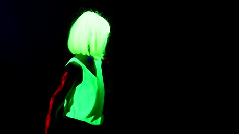 Woman-with-UV-face-paint,-wig,-glowing-clothing-dancing-in-side-way,-Half-body-shot.-Caucasian-woman.-.