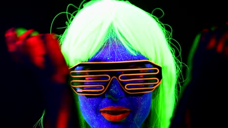 Woman-with-UV-face-paint,-wig,-UV-glasses,-glowing-clothing-portrait,-face-close-up-of-make-up.-Caucasian-woman.-.