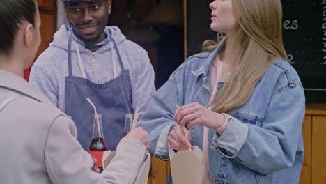 Caucasian-girls-eating-in-street-cafe