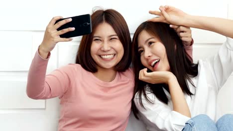 Beautiful-couple-women-selfie-together-with-attractive-smiling.-Asian-women-using-camera-in-smartphone-for-selfie-together.