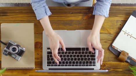 Top-View-of-Female-Freelancer-Typing-on-Laptop