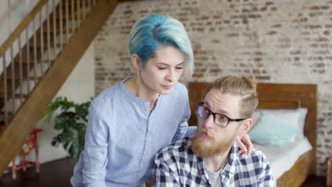 Girlfriend-Bringing-Coffee-to-Boyfriend-Working-on-Laptop