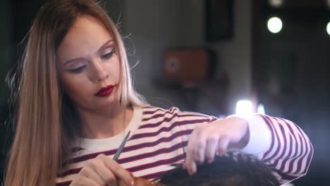 Close-up,-master-hairdresser-does-hairstyle-and-style-with-scissors-and-comb.-Concept-Barbershop