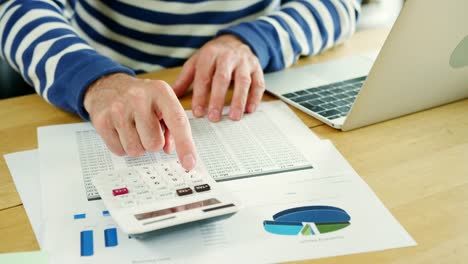 Businessman-Analysing-And-Calculation-Financial-Data-At-His-Desk