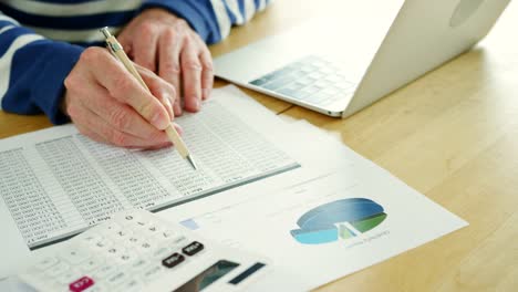 Businessman-Analysing-And-Calculation-Financial-Data-At-His-Desk