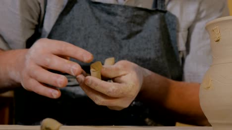 Professional-male-potter-working-in-workshop,-studio