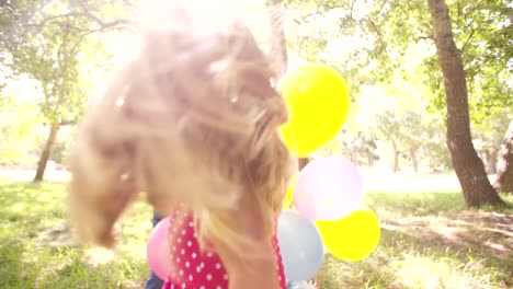 Friendly-happy-children-having-fun-with-balloons-outdoors