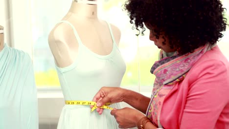 Fashion-designer-measuring-dummy-waist