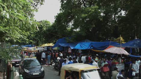 Locked-on-shot-of-people-at-market-stall,-Delhi,-India