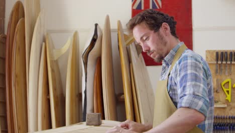 Man-Building-Custom-Surfboard-In-Workshop-Shot-On-RED-Camera