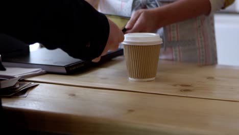 Man-In-Coffee-Shop-Using-Contactless-Payment-Shot-On-R3D