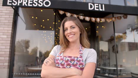 White-female-owner-walks-into-focal-plane-outside-cafe