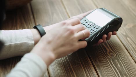 Woman-swiping-credit-card-through-credit-card-reader