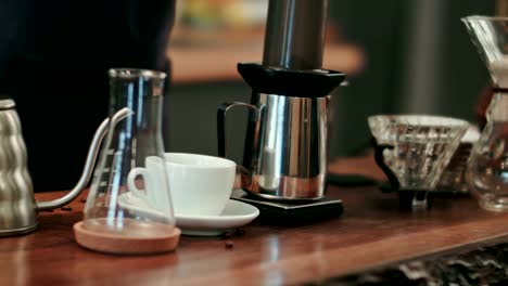 Barista-pouring-water-on-coffee-ground-with-filter