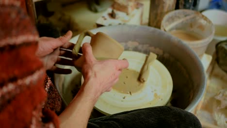 Professional-male-potter-working-in-workshop,-studio